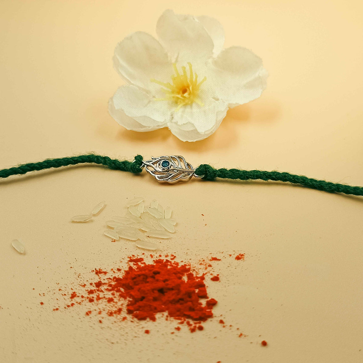 Peacock Feather Handcrafted 92.5 Silver Rakhi with Blue Stone
