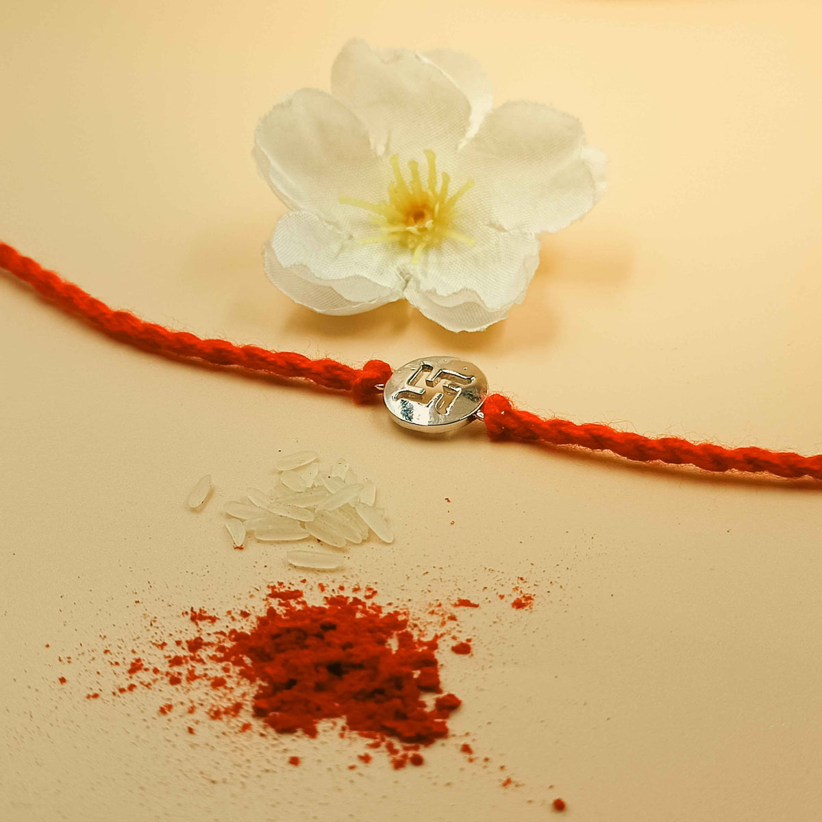 Swastik Handcrafted 92.5 Silver Rakhi with Red Thread