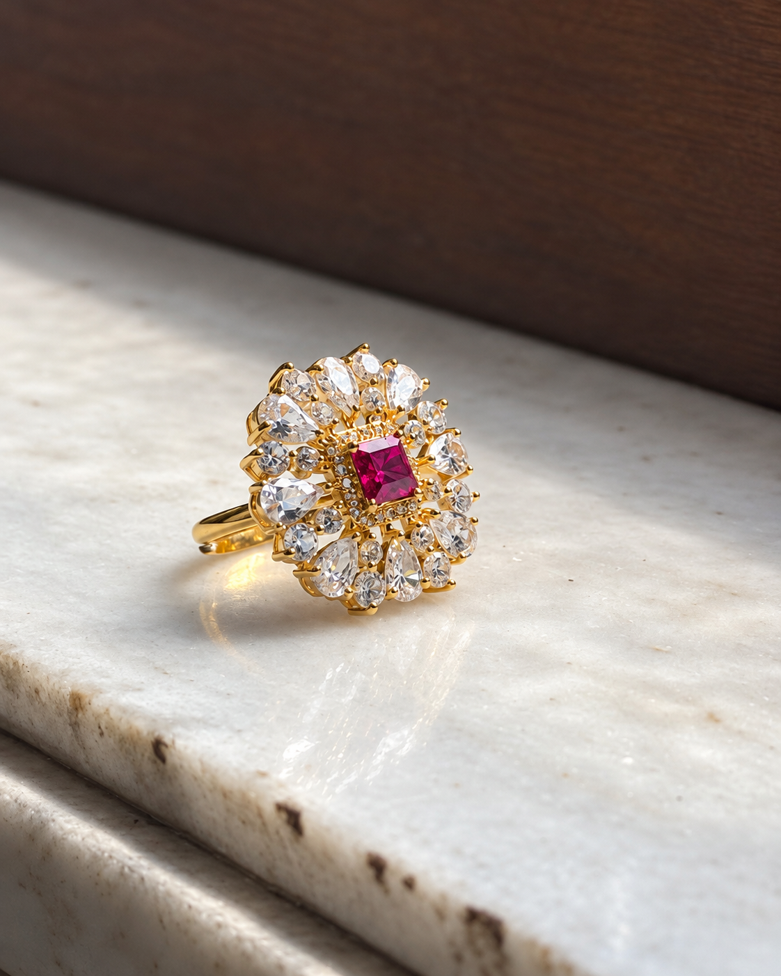 Front view of red onyx cocktail ring with a floral white stone halo and gold-tone setting