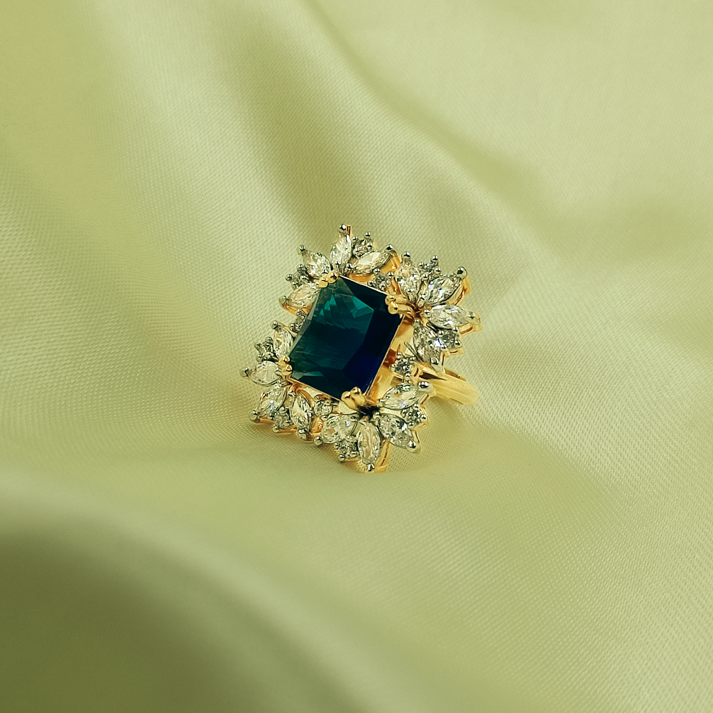 Deep blue rectangular statement ring with clear marquise floral halo