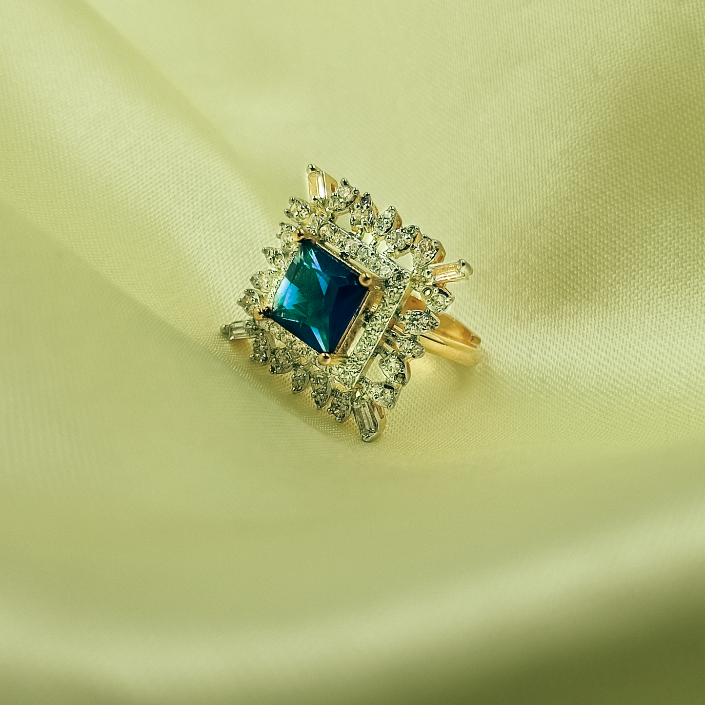 Square blue and teal cocktail ring with mixed clear halo and gold-tone band