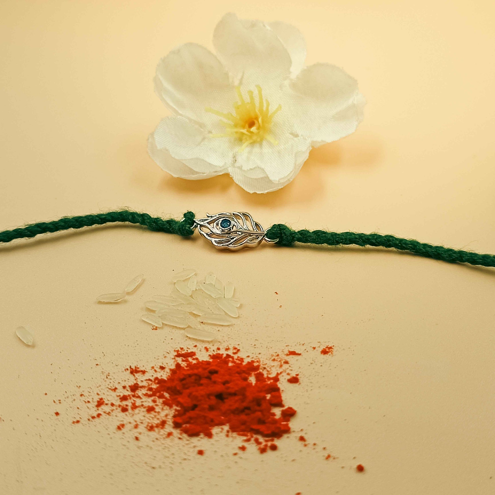 Peacock Feather Handcrafted 92.5 Silver Rakhi with Blue Stone