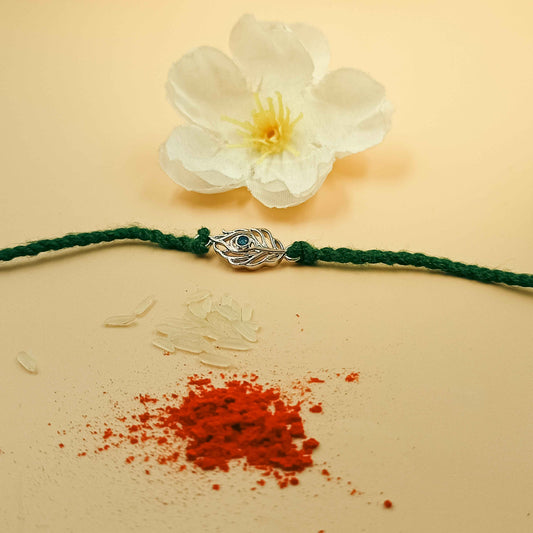 Peacock Feather Handcrafted 92.5 Silver Rakhi with Blue Stone